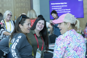 Group of women looking at each other smiling at the Women in Hort Get Together