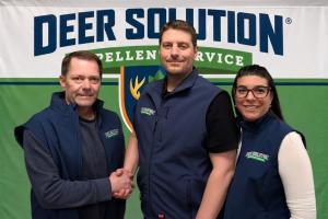 Deer Solution of Southwest Michigan owner Brian Wolf shakes hands with co-founders Kris and Jaime Goodrich