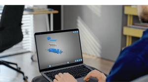 Person using a laptop to view an interactive 3D exploded view of an industrial temperature gauge on the saVRee learning platform.