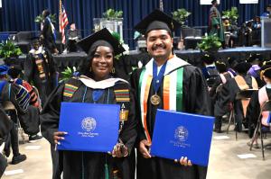 Two students at ASU Commencement Holding Degrees