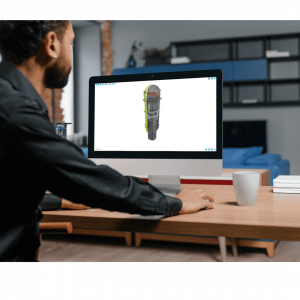 Man at a desk viewing an interactive 3D cutaway model of a nuclear reactor pressure vessel on his desktop computer using the saVRee learning platform.