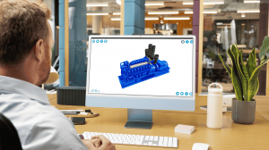 Man at an office desk viewing an interactive 3D model of a large industrial diesel generator on his desktop computer using the saVRee learning platform.