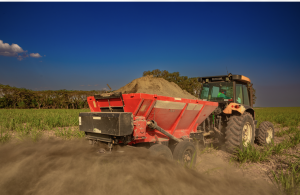Rock powder being actively spread on farmland using standard machinery commonly available on farms.