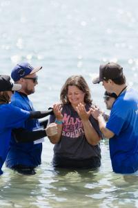A participant is prayed over before being baptized during Baptize California at Pirates Cove in Corona del Mar, where more than 1,000 people were baptized in the Pacific Ocean. Photo courtesy of Baptize California.