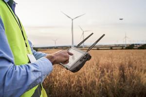 A field engineer using a Getac rugged tablet to control drones to inspect utilities operations