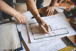 A construction project planning meeting with blueprints.