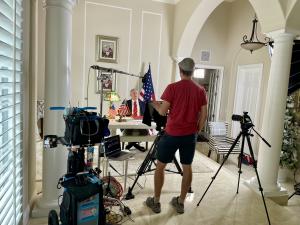 Elite Video crew filming corporate video interview on location in Orlando with professional lighting and 4K camera setup