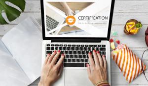 photo of a health professional typing on a lap top words on the screen are Certified