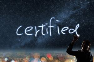 photo of the sky at dusk with city line in the back ground, a health professional pointing to the word Certify in the sky