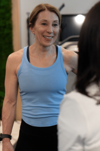 Patient smiling while speaking with a MetaLab staff member during a wellness consultation at Confidia Health Institute.