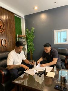EPIQ Superfoods CEO Nestor Bonifacio Jr. and President Dean Michael Roxas signing official documents during a leadership appointment ceremony.