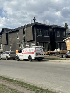 Idi owner & operator of INA Soft Metals on a roof inspection eaves post hail damage in Calgary