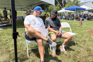 Dr. Kevin Greene speaks with a community member during an outdoor wellness and fitness event as part of Confidia Health Institute’s patient-centered preventive care approach.