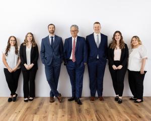 The Nowlan Injury Law team standing together in the announcement of the firm’s new Madison, Wisconsin office location.