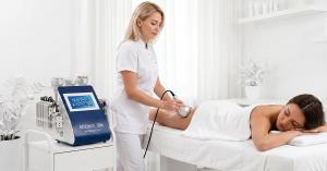 Professional body contouring treatment using the 2026 Adonis II cavitation system in a modern clinical spa setting