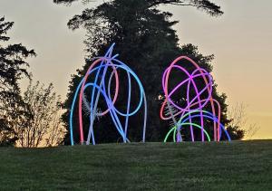 An image of two outdoor sculptures that glows in the dark.