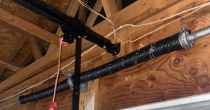 Close-up of a technician installing new, quiet nylon garage door rollers on a residential door in the Hastings Ranch neighborhood of Pasadena.