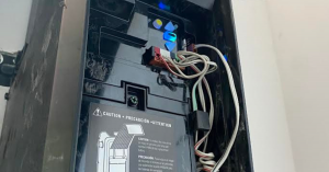 Pasadena Garage Door Experts technician realigning bent steel tracks and tensioning lift cables for a residential overhead door.