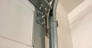 Performing specialized hardware maintenance on a heavy, custom wood carriage-style garage door in the historic Bungalow Heaven neighborhood of Pasadena.