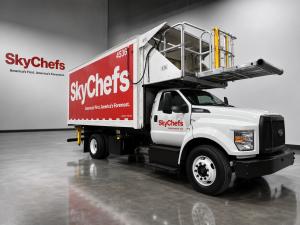 A large catering truck with a red box that shows the Sky Chefs logo in white.