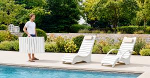 Three AquaCurve pool lounger styles shown near a backyard pool, including compact, chaise-style and armrest lounge chair options.