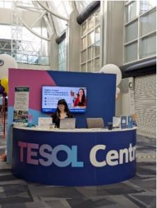 Main entrance area of the TESOL conference with attendees gathering and walking through the venue.