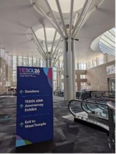 Attendees interacting and networking in a common area at the TESOL conference venue.