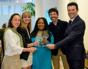 a group of wine professionals share a toast