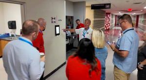 Cody Little, Assistant Principal of Mustang High, shows staff from neighboring schools the newly installed tardy stations.