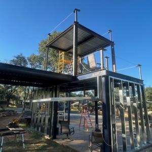 External view of 2-story Gilayo structure with full glass wing walls