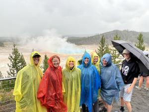 Teton Excursions private tour group in rain ponchos at Grand Prismatic Spring, Yellowstone National Park