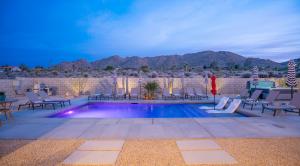 View from the patio looking at the pool, the desert hillside and evening sky