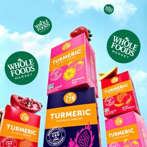 Drink ZYN Turmeric Electrolyte Drink Mix cartons in 3 flavors, Strawberry Yuzu, Blackberry Dragon Fruit and Mango Pomegranate along with the Whole Foods Market logos floating on a sky like background