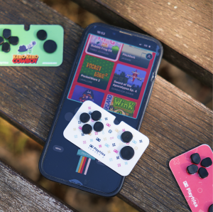 Playtiles controllers placed on an outdoor bench, with one of them resting on a phone that has the PlaytilesOS app open, displaying the library of available games.