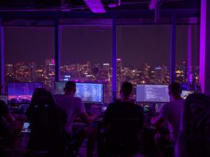 QScout Pulse overnight cybersecurity operations team monitoring live quantum risk and vulnerability intelligence dashboards at night.