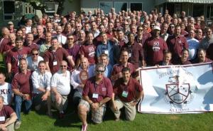A large group of Delta Kappa Kappa fraternity brothers celebrate together