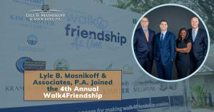 Florida work-related injury lawyers standing beside press release title: Lyle B. Masnikoff & Associates, P.A. Joined the 4th Annual Walk4Friendship.