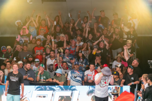 Large crowd cheers during The Throwdown Cornhole Festival in Ventura, California as attendees gather around the competition stage during a lively indoor event. Ventura is a city within Ventura County Coast
