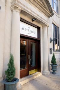 Historic exterior and main entrance of The Aldenberg boutique hotel in downtown Versailles, Kentucky.