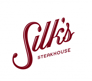 Logo for Silk's, a premier steakhouse and regional dining destination at The Aldenberg in Versailles, Kentucky.