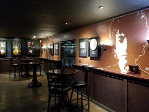 Signed guitars and rock memorabilia displayed inside Rockefellas Bar in Corona.