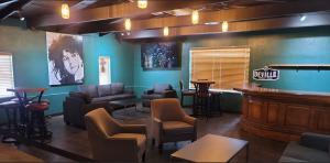 Lounge seating area inside Rockefellas Bar with tables, sofas, and bar-style atmosphere.