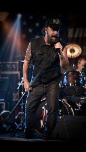 Portrait-style performance image of singer and presenter Brad Henshaw.