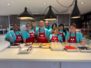 ArrowHeart volunteers pose for a picture at the Ronald McDonald House in Phoenix, AZ before serving families the breakfast they prepared.