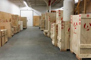 Rows of Atelier 4 branded wooden art crates in a climate-controlled storage facility