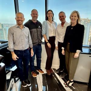 Group photo in office, subjects Larry Smalheiser, Managing Director at WOC | Signal, Dylan Natter, Chief Executive Officer & Founder at centrexIT, Andrea Saxenhofer, Associate Director at WOC | Signal, Grant Wright, CEO & Managing Partner at (W)right On C