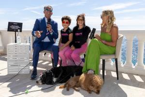 Dr. Daniel Pompa and his wife Merily Pompa record a live podcast episode alongside the Lolli children at the sHEALed Global Podcast Pavilion on the French Riviera during the 2026 Cannes Film Festival.
