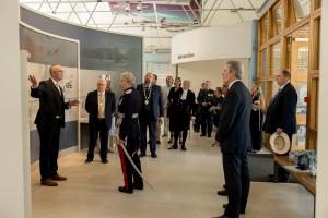 Cambridge American Cemetery Superintendent John Bolt provides a tour of the newly redesigned visitor center exhibition May 25, 2026, after the ribbon cutting. (ABMC/Richard Howell)