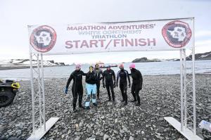 Six athletes at the starting line of the 2025 White Continent Triathlon in Antarctica.
