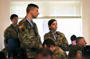 Two army soldiers watching the training